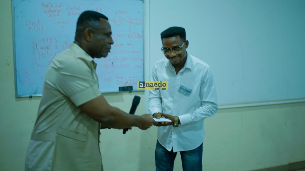 Mr. Endi Ezengwa presenting cash gift to Mr. Ifeanyi Joseph Okeke