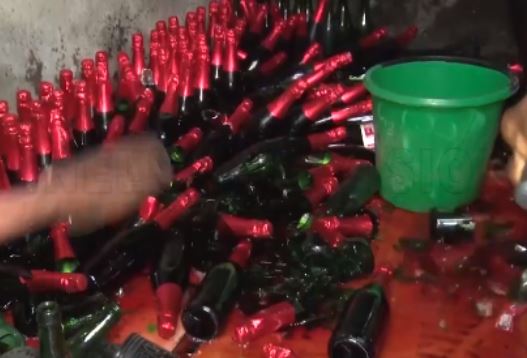 fake wines being destroyed at cemetery market