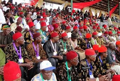 Igbo men adorned in traditional attire seated together in unity, showcasing Igbo culture,